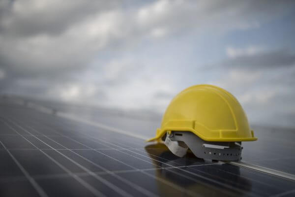 Yellow safety helmet on solar cell panel